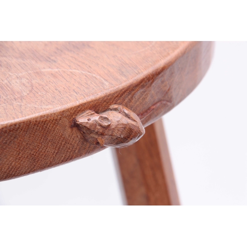 935 - A ROBERT MOUSEMAN THOMPSON ADZED OAK COW STOOL OF GENEROUS SIZE the dished heart-shaped top with car... 