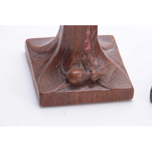 936 - A PAIR OF EARLY ROBERT MOUSEMAN THOMPSON OAK CANDLESTICKS with leaf carved sconces and facetted ring... 