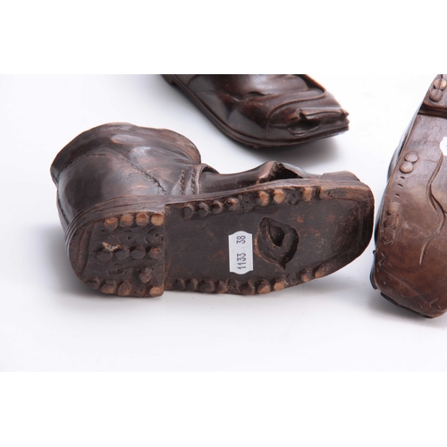 939 - A PAIR AND SINGLE LATE 19TH CENTURY SWISS CARVED BOOTS the pair 15cm wide the single 16cm wide (3).