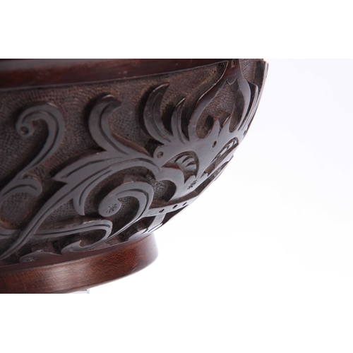 940 - AN EARLY 20TH CENTURY CARVED CIRCULAR BOWL with leaf work decoration and dated 1907 30cm diameter 12... 