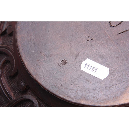 940 - AN EARLY 20TH CENTURY CARVED CIRCULAR BOWL with leaf work decoration and dated 1907 30cm diameter 12... 