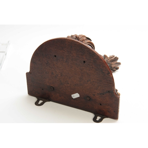 941 - A LATE 19th CENTURY WALNUT AND OAK CARVED BRACKET having a floral spray and fruit 30cm high