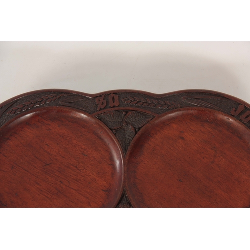 942 - A LATE 19TH CENTURY MAHOGANY SHALLOW REVOLVING TABLE DUMB WAITER the scallop-edged dished top on a c... 