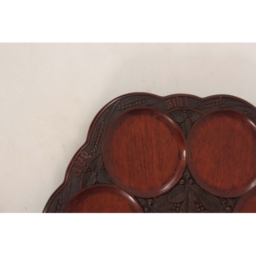 942 - A LATE 19TH CENTURY MAHOGANY SHALLOW REVOLVING TABLE DUMB WAITER the scallop-edged dished top on a c... 