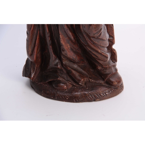 947 - A 17TH CENTURY CARVED LIMEWOOD FIGURE OF A SAINT finely carved with a good patination 48cm high.