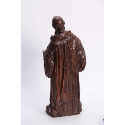 947 - A 17TH CENTURY CARVED LIMEWOOD FIGURE OF A SAINT finely carved with a good patination 48cm high.