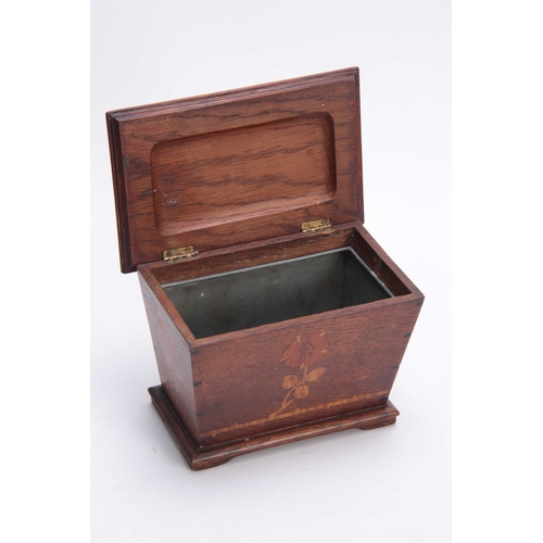 953 - AN ARTS AND CRAFT INLAID OAK TEA CADDY of tapered form with moulded hinged top above a floral inlaid... 