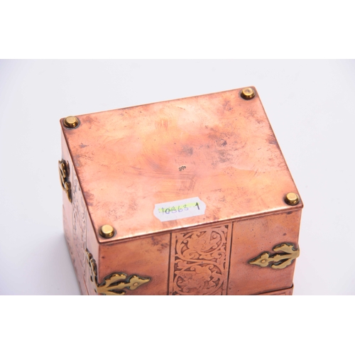 955 - AN ARTS AND CRAFTS NEWLYN TYPE COPPER BOX with brass strap hinges and corner mounts enclosing emboss... 