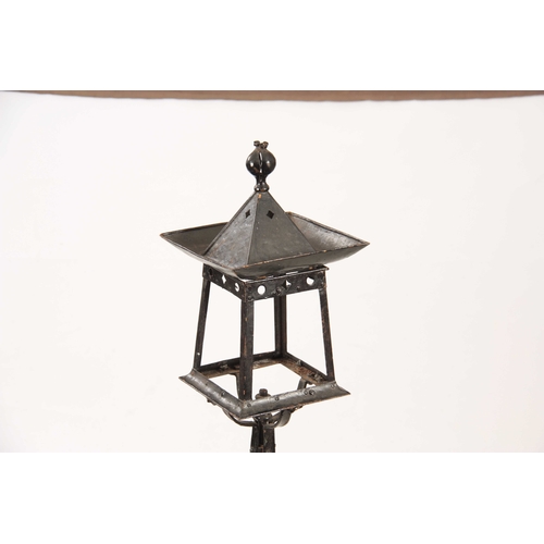 962 - AN ARTS AND CRAFT PAINTED METAL NEWEL POST LANTERN of square stylised form with tapering supports an... 