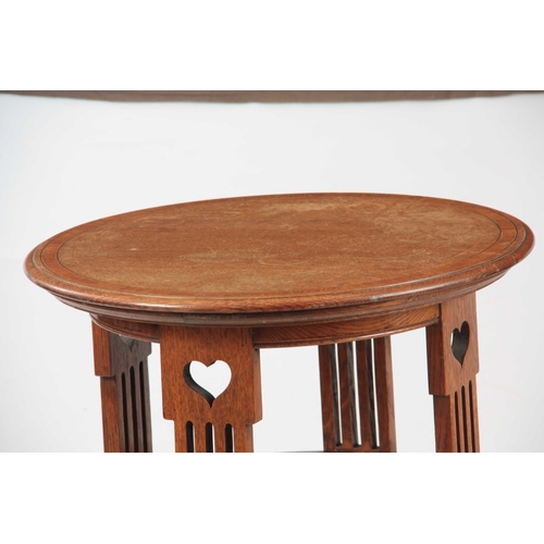 963 - A LIBERTY STYLE ARTS AND CRAFTS OAK OCCASIONAL TABLE having a circular top with kingwood crossbandin... 