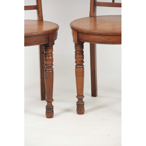 966 - A PAIR OF ARTS AND CRAFTS OAK HALL CHAIRS with raised oval panel on the backrest and matching oval s... 