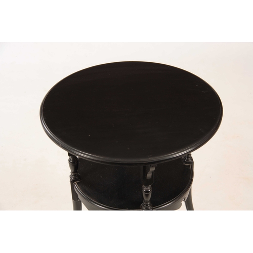 969 - AN ARTS AND CRAFT STYLE EBONISED OCCASIONAL TABLE IN THE MANER OF GODWYN HALL having a circular top ... 