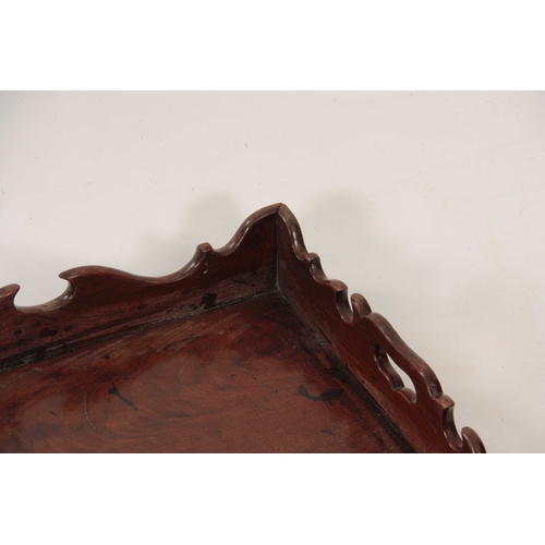 974 - A GEORGE III FIGURED MAHOGANY RECTANGULAR TRAY with shaped gallery and cutout side handles 58cm wide... 