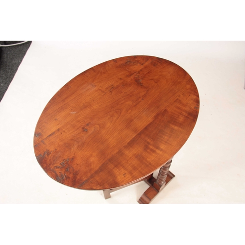 977 - AN 18TH CENTURY CHERRY WOOD FOLDING COACHING TABLE with oval plank top above a ring turned hinged ba... 