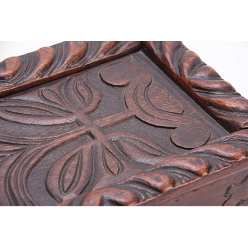 979 - A LATE 17TH CENTURY CARVED OAK CANDLE BOX with sliding top having a gadrooned edge and flower carved... 