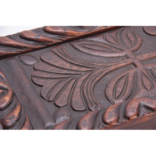 979 - A LATE 17TH CENTURY CARVED OAK CANDLE BOX with sliding top having a gadrooned edge and flower carved... 