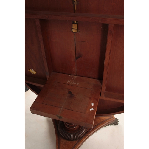 987 - A REGENCY PLUM PUDDING MAHOGANY CENTRE TABLE with wide cross-banded tilt top; standing on a ring tur... 