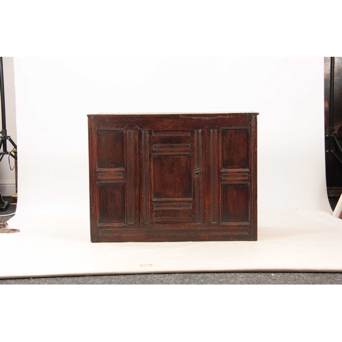 993 - A 17TH CENTURY OAK WELSH HANGING FOOD CUPBOARD constructed of joined panels with central hinged door... 