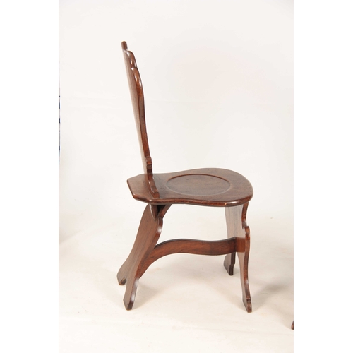 994 - A PAIR OF GEORGE II OAK HALL CHAIRS the slightly bowed shaped solid backs on dished rounded seats an... 