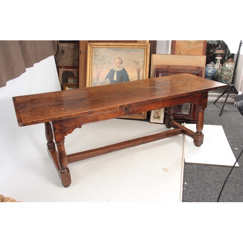 997 - A GOOD LATE 17TH CENTURY OAK REFECTORY / FARMHOUSE TABLE with one-piece plank top, above a plain fri... 