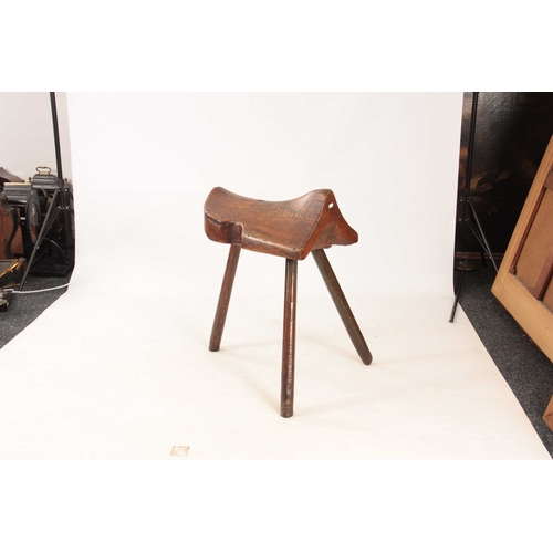 999 - AN UNUSUAL 18TH CENTURY ELM SADDLE STAND on chamfered stick legs - sold with a leather saddle 76cm h... 