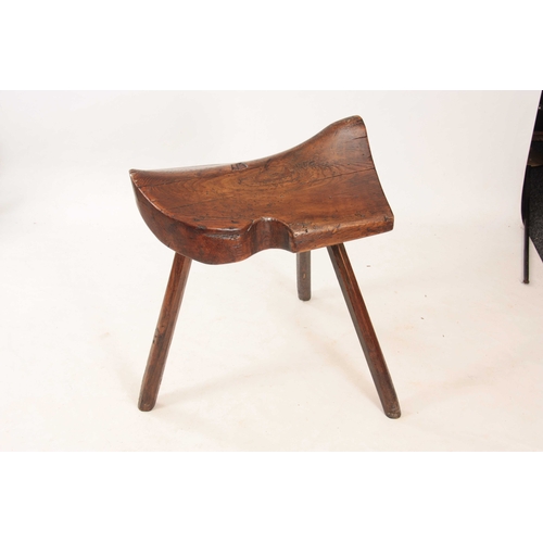 999 - AN UNUSUAL 18TH CENTURY ELM SADDLE STAND on chamfered stick legs - sold with a leather saddle 76cm h... 