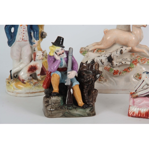 100 - A SELECTION OF FIVE 19TH CENTURY STAFFORDSHIRE FIGURES comprising of a hound hunting staff spill vas... 