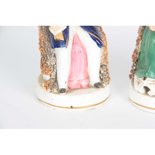 105 - A PAIR OF 19TH CENTURY STAFFORDSHIRE FIGURES depicting Victoria and Albert 17cm high.