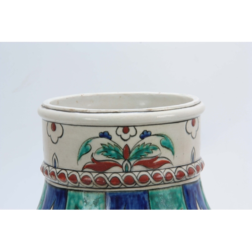 116 - A 19TH CENTURY ISNIC BALUSTER VASE decorated with brightly coloured leaf work bands 35cm high.