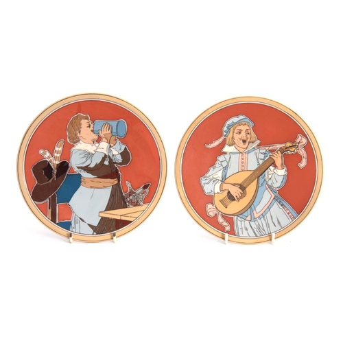 123 - A PAIR OF METTLACH HANGING PLAQUES depicting a pair of figures in drinking and musical pursuits 20cm... 