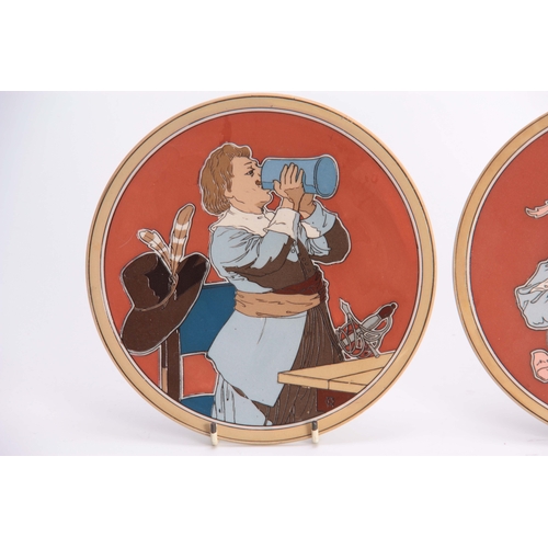 123 - A PAIR OF METTLACH HANGING PLAQUES depicting a pair of figures in drinking and musical pursuits 20cm... 