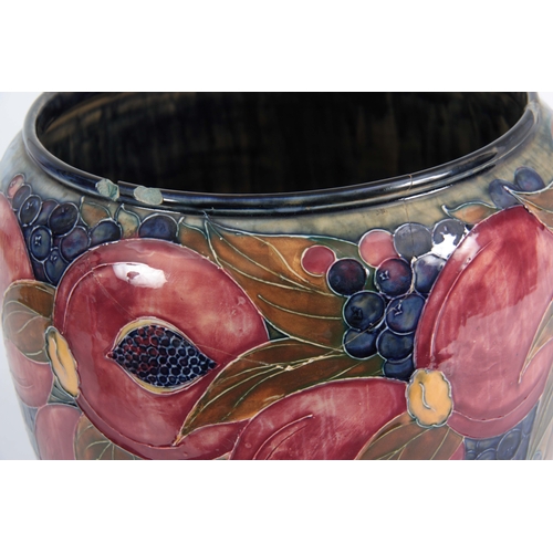 43 - A 20TH CENTURY MOORCROFT  JARDINIERE decorated with pomegranates and grapes bearing green signature ... 