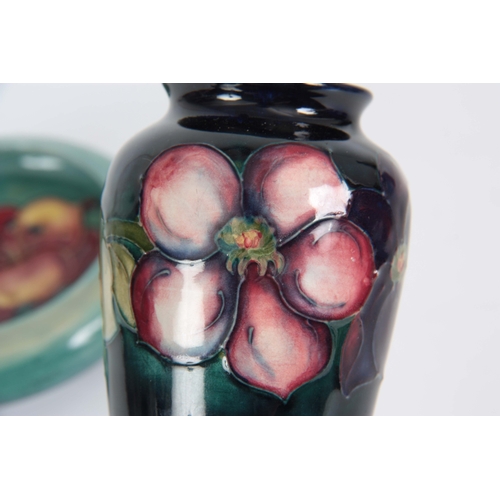 49 - A 1930's MOORCROFT SMALL TAPERING SHOULDERED VASE tube lined and decorated with a continuous band of... 