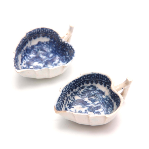 75 - AN EARLY PAIR OF BLUE AND WHITE LEAF SHAPED PEARLWARE PICKLE DISHES with oriental landscape decorati... 