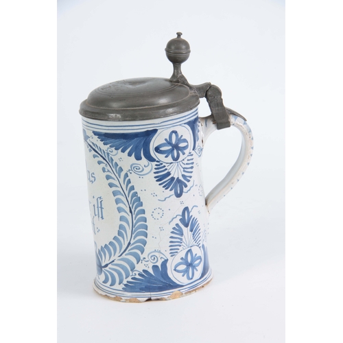 87 - AN 18TH CENTURY GERMAN BLUE AND WHITE PEWTER MOUNTED DELFT TANKARD bearing inscription ‘Das bie ift ... 