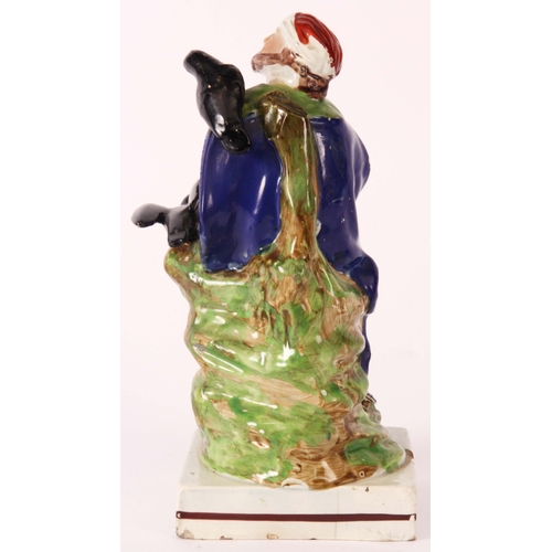 106 - An early 19th Century Ralph Wood type pearlware polychrome FIGURE of ELIJAH modelled in a seated pos... 