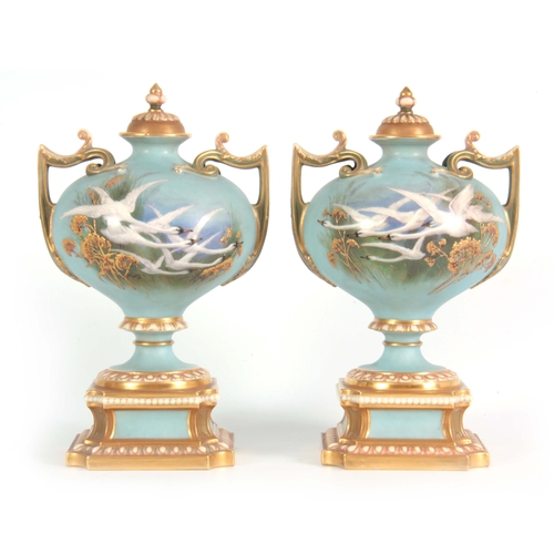 110 - AN UNUSUAL SHAPED  A PAIR OF ROYAL WORCESTER LIDDED CABINET VASES BY CHARLES BALDWYN having bulbous ... 