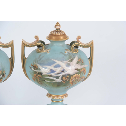 110 - AN UNUSUAL SHAPED  A PAIR OF ROYAL WORCESTER LIDDED CABINET VASES BY CHARLES BALDWYN having bulbous ... 