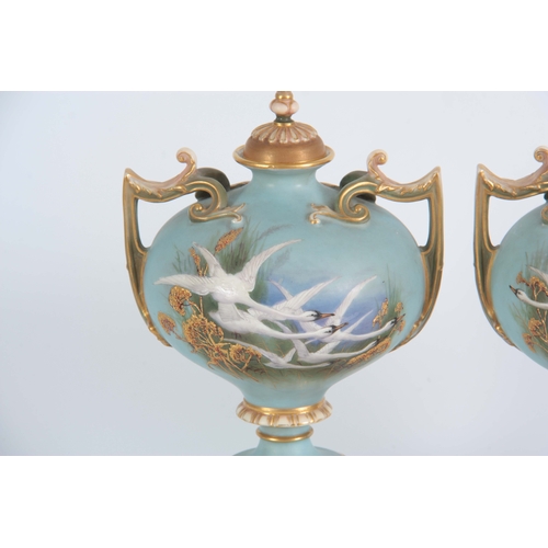 110 - AN UNUSUAL SHAPED  A PAIR OF ROYAL WORCESTER LIDDED CABINET VASES BY CHARLES BALDWYN having bulbous ... 