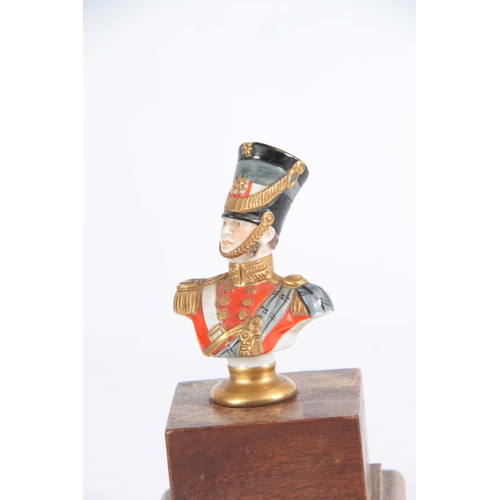 128 - A MID 20TH CENTURY GERMAN PORCELAIN FIGURE OF A 19TH CENTURY OFFICER BY KAMMER RUDOLPH written to re... 