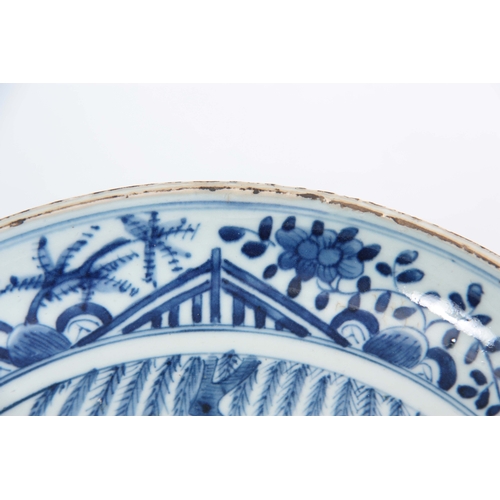 136 - A 17TH / 18TH CENTURY CHINESE BLUE AND WHITE DISH decorated with figures in a garden and on horse ba... 