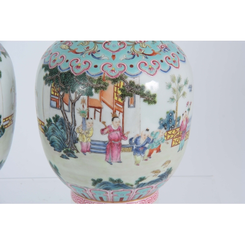 138 - A PAIR OF CHINESE REPUBLIC LATE 19TH CENTURY FAMILLE ROSE VASES decorated with continuous garden sce... 