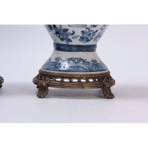 157 - A PAIR OF ORIENTAL BLUE AND WHITE BALUSTER VASES WITH PIERCED METAL BASES AND SCROLL FEET allover de... 