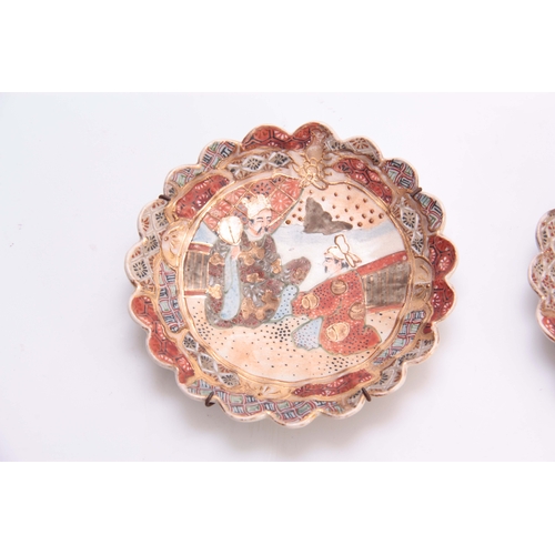 170 - A PAIR OF 20TH CENTURY JAPANESE SATSUMA SIDE PLATES with scalloped edges, decorated with figures 17c... 