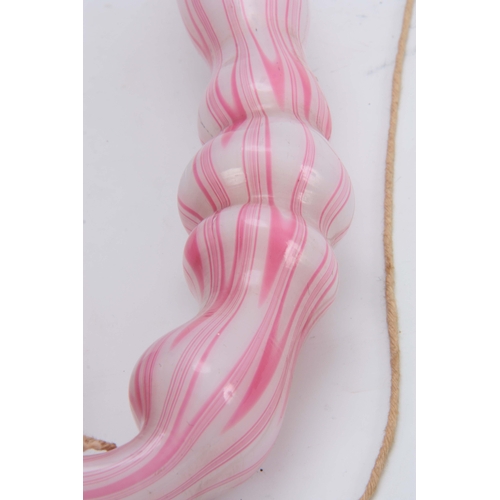 18 - A LARGE 19TH CENTURY STOURBRIDGE GLASS PIPE of twisted pink and opaque design 50cm overall.