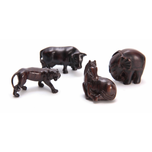 181 - A COLLECTION OF FOUR EARLY 20th CENTURY NETSUKE sculptured as various animals three with character m... 