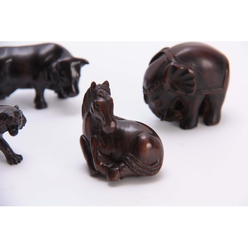 181 - A COLLECTION OF FOUR EARLY 20th CENTURY NETSUKE sculptured as various animals three with character m... 