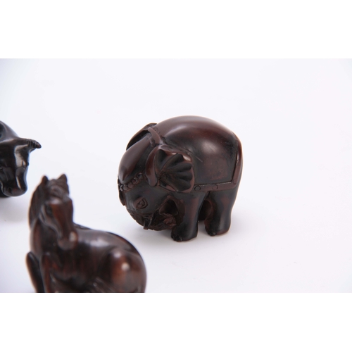 181 - A COLLECTION OF FOUR EARLY 20th CENTURY NETSUKE sculptured as various animals three with character m... 