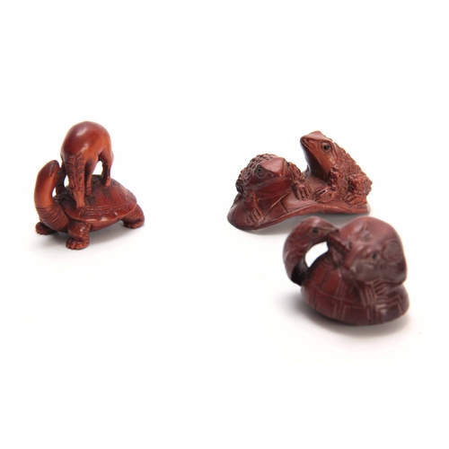 182 - A COLLECTION OF THREE EARLY 20th CENTURY HARDWOOD NETSUKE sculptured as various animals all with cha... 