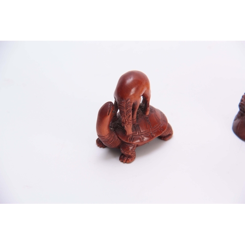 182 - A COLLECTION OF THREE EARLY 20th CENTURY HARDWOOD NETSUKE sculptured as various animals all with cha... 